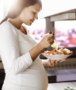 Pregnant woman eating a healthy meal