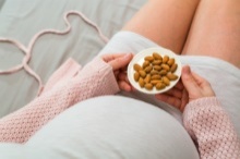 Pregnant woman eating almonds